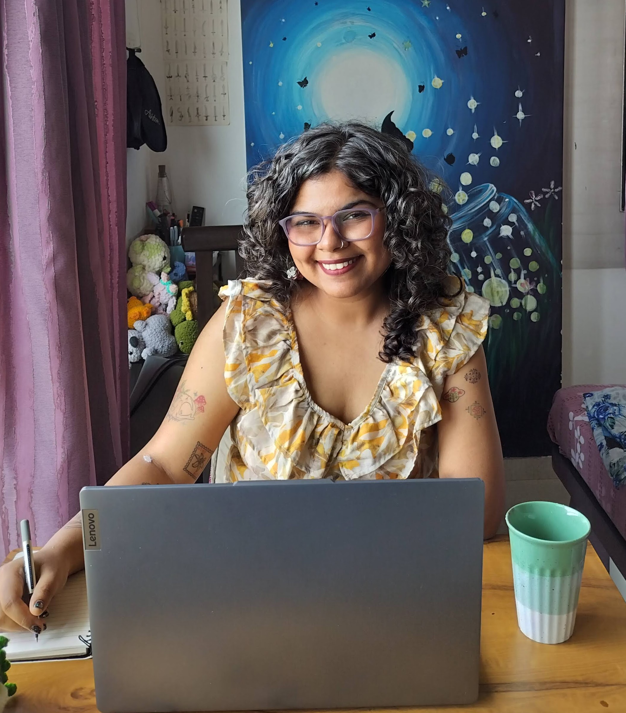 Durva Bhatt at her workspace, with a notebook and laptop