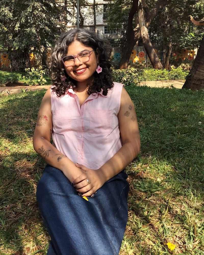 Durva, sitting on grass in a park